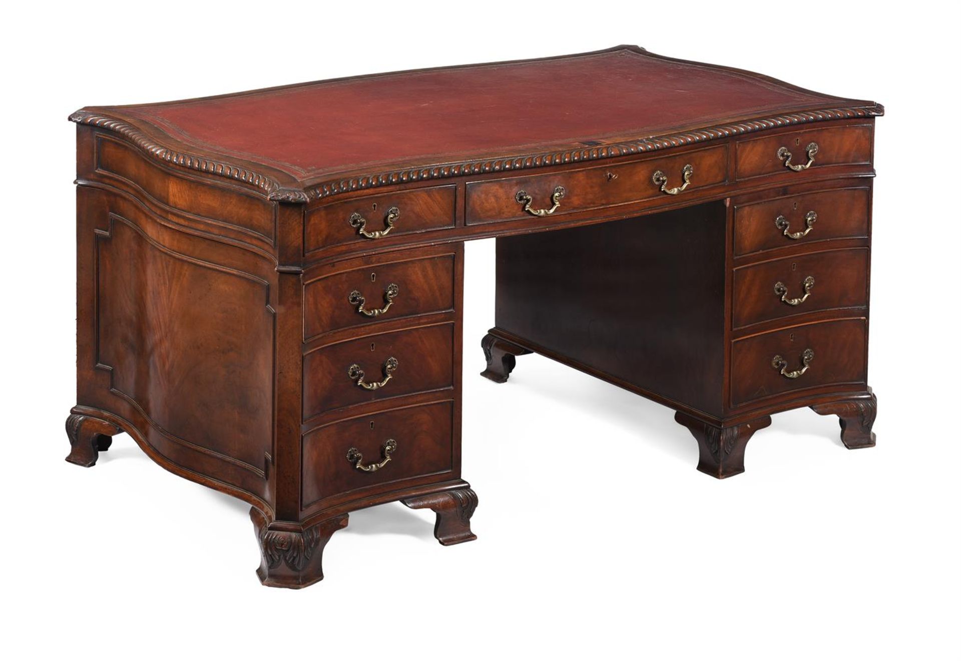 A MAHOGANY SERPENTINE SHAPED PEDESTAL DESK, IN GEORGE III STYLE, 20TH CENTURY