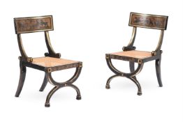 A PAIR OF REGENCY EBONISED AND PARCEL GILT ARMCHAIRS, IN THE MANNER OF THOMAS HOPE, CIRCA 1820