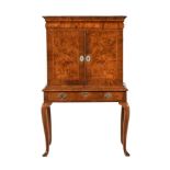 A QUEEN ANNE WALNUT, FIGURED WALNUT AND FEATHER BANDED CABINET, CIRCA 1710