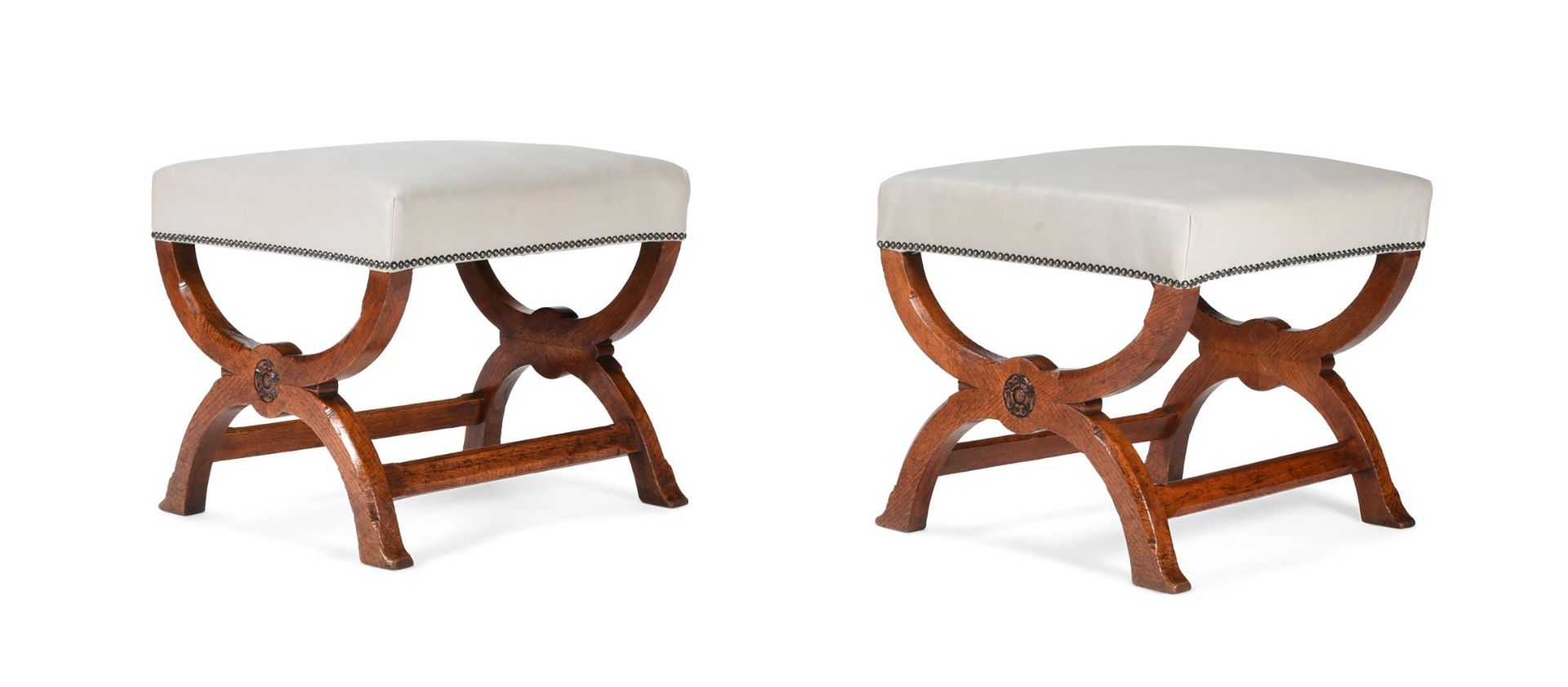 A PAIR OF EARLY VICTORIAN OAK AND LEATHER UPHOLSTERED STOOLS, BY GILLOWS, MID 19TH CENTURY