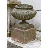 A PAIR OF STONE COMPOSITION VASES ON PLINTHS, 20TH CENTURY