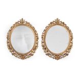 A PAIR OF GILTWOOD AND COMPOSITION OVAL MIRRORS, SECOND HALF 19TH CENTURY