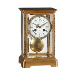A FRENCH GILT BRASS AND CHAMPLEVE ENAMELLED FOUR-GLASS MANTEL CLOCK