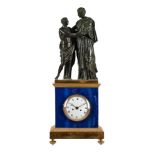 A RARE EMPIRE PERIOD PATINATED BRONZE, ORMOLU AND LAPIS LAZULI FIGURAL MANTEL CLOCK