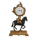 A FRENCH ORMOLU AND PATINATED BRONZE SMALL ‘PENDULE AU CHEVAL’ TIMEPIECE
