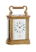 AN ENGRAVED GILT BRASS BOW-SIDED REPEATING CARRIAGE CLOCK WITH ALARM