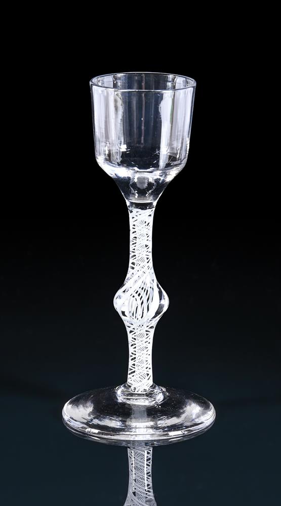 AN OPAQUE TWIST WINE GLASSTHIRD QUARTER 18TH CENTURYWith Ogee bowl and centrally knopped stem15c