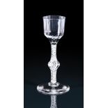 AN OPAQUE TWIST WINE GLASSTHIRD QUARTER 18TH CENTURYWith Ogee bowl and centrally knopped stem15c