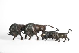 A GROUP FOUR BRONZE MODELS OF BULLS IN JAPANESE STYLE