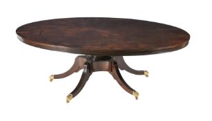 A MAHOGANY EXTENDING DINING TABLE IN REGENCY STYLE