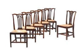 A SET OF SIX GEORGE III OAK AND RUSH SEATED DINING CHAIRS