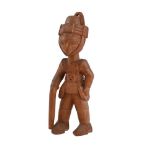 A YORUBA COLONIAL CARVED WOOD FIGURE OF A SOLDIER