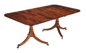 A MAHOGANY TWIN PEDESTAL DINING TABLE IN LATE GEORGE III STYLE
