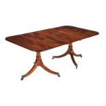 A MAHOGANY TWIN PEDESTAL DINING TABLE IN LATE GEORGE III STYLE