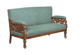 A VICTORIAN CARVED MAHOGANY AND UPHOLSTERED SOFA