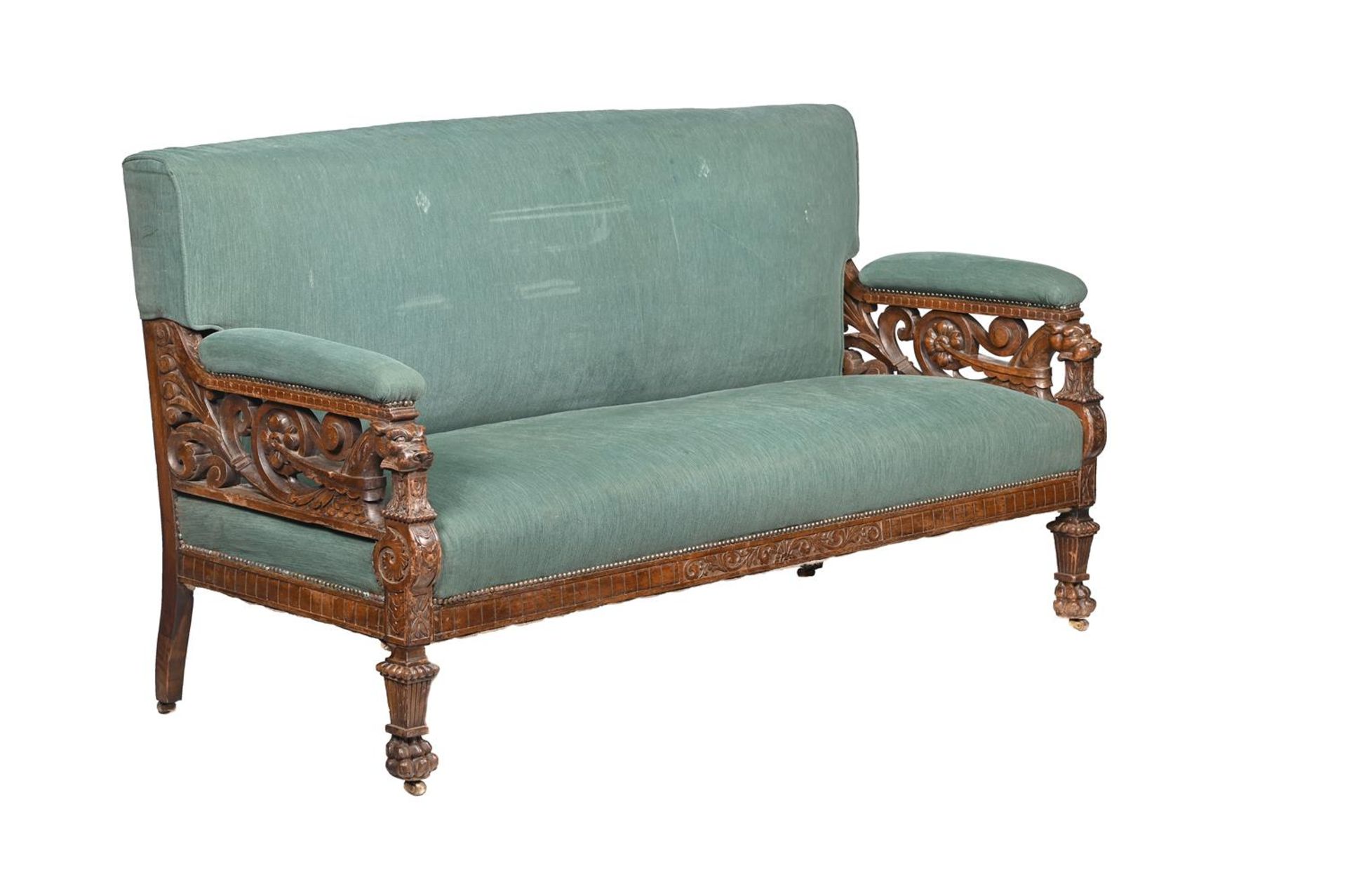 A VICTORIAN CARVED MAHOGANY AND UPHOLSTERED SOFA