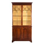 A MAHOGANY BOOKCASE CABINET IN GEORGE III STYLE