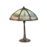 AN ART NOUVEAU AMERICAN TABLE LAMP BASE AND REVERSE PAINTED GLASS SHADE