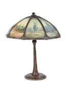 AN ART NOUVEAU AMERICAN TABLE LAMP BASE AND REVERSE PAINTED GLASS SHADE