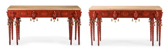 A PAIR OF RED PAINTED AND PARCEL GILT CONSOLE TABLES IN CHINOISERIE TASTE