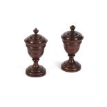 A PAIR OF TURNED MAHOGANY SALT/CONDIMENT POTS AND COVERS