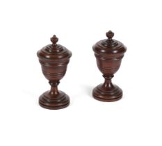 A PAIR OF TURNED MAHOGANY SALT/CONDIMENT POTS AND COVERS