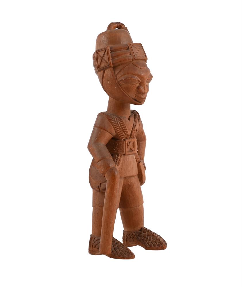 A YORUBA COLONIAL CARVED WOOD FIGURE OF A SOLDIER - Image 2 of 2