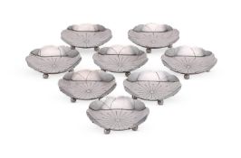 A SET OF EIGHT SILVER SHAPED CIRCULAR DISHES