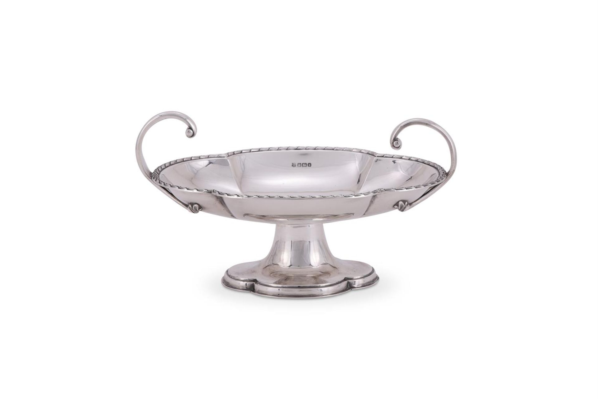 AN EDWARDIAN SILVER SHAPED OVAL PEDESTAL BOWL