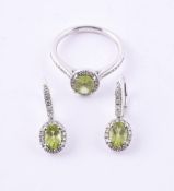 A PERIDOT AND DIAMOND CLUSTER RING AND A MATCHING PAIR OF EAR PENDANTS, LONDON 2007