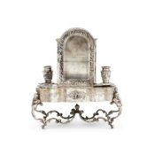 A GERMAN SILVER COLOURED INKSTAND IN THE FORM OF A MINIATURE CABINET ON TABLE