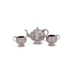 AN INDIAN SILVER SWAMI THREE PIECE LOBED CIRCULAR TEA SET