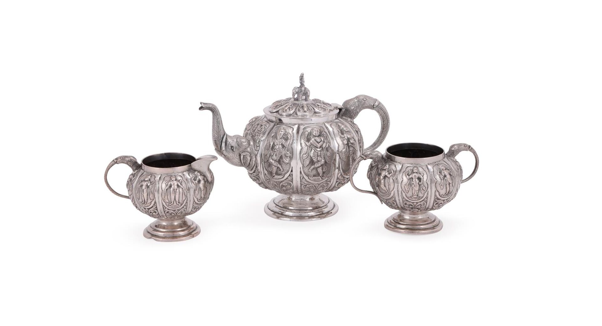 AN INDIAN SILVER SWAMI THREE PIECE LOBED CIRCULAR TEA SET