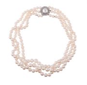 A THREE STRAND CULTURED PEARL NECKLACE WITH A MABÉ PEARL AND DIAMOND CLUSTER CLASP