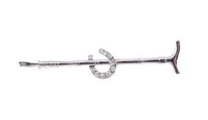 A MID 20TH CENTURY DIAMOND SET RIDING CROP AND HORSE SHOE STOCK PIN