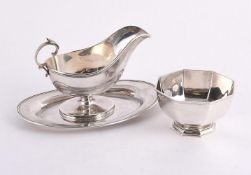 A CANADIAN SILVER COLOURED OVAL SAUCE BOAT AND DISH