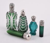 FIVE GREEN GLASS SCENT BOTTLES WITH WHITE METAL MOUNTS