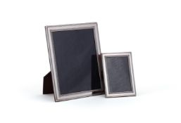 A GRADUATED PAIR OF SILVER MOUNTED PHOTOGRAPH FRAMES