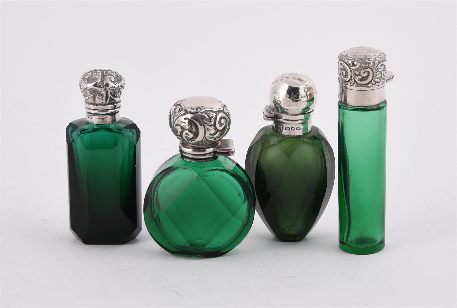 FOUR SILVER MOUNTED AND GREEN GLASS SCENT BOTTLES