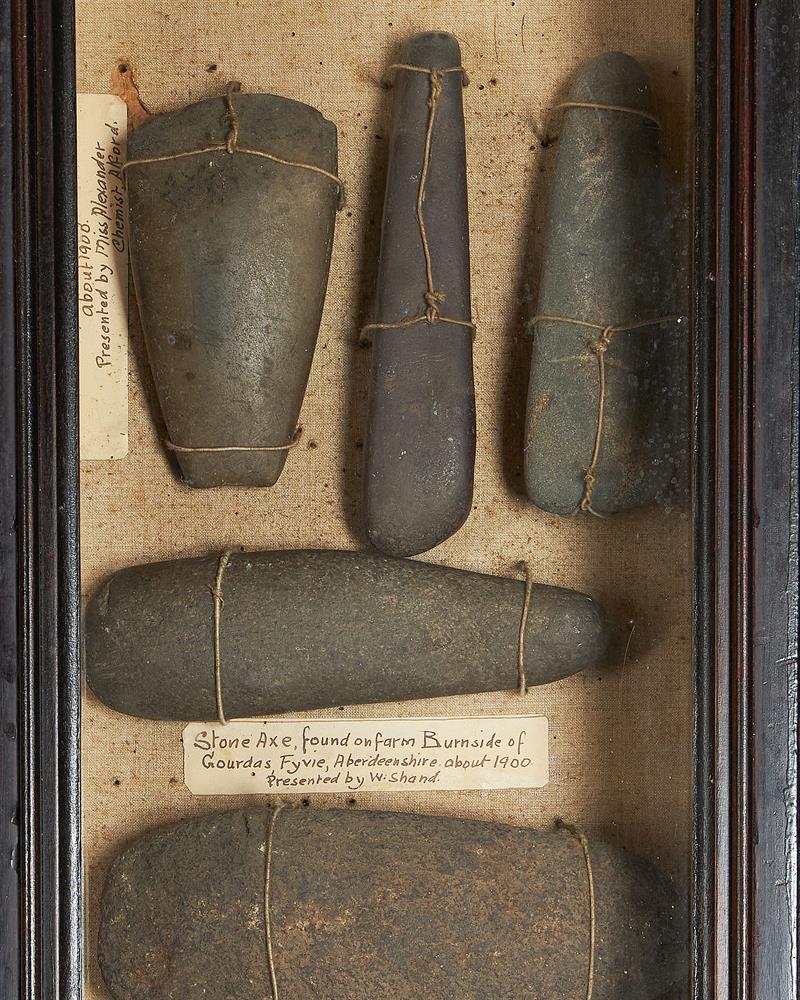 A GLAZED FRAMED CASE CONTAINING FLINT HAND AXES AND STONE AXES, CIRCA 2000 B.C. AND EARLIER - Image 2 of 2