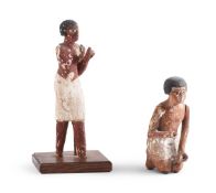 TWO EGYPTIAN POLYCHROME PAINTED WOOD FIGURES MIDDLE KINGDOM, CIRCA 2025-1700 B.C.