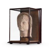 AN ETRUSCAN TERRACOTTA VOTIVE HEAD OF A YOUTH, CIRCA 4TH-3RD CENTURY B.C.