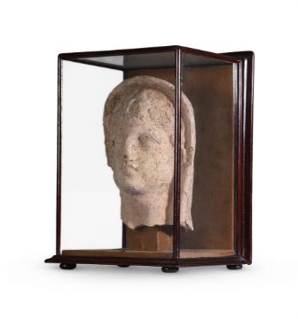AN ETRUSCAN TERRACOTTA VOTIVE HEAD OF A YOUTH, CIRCA 4TH-3RD CENTURY B.C.