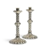 A PAIR OF ARTS AND CRAFTS SILVER PLATED CANDLESTICKS,CIRCA 1890, IN THE MANNER OF HART, SON & PEARD