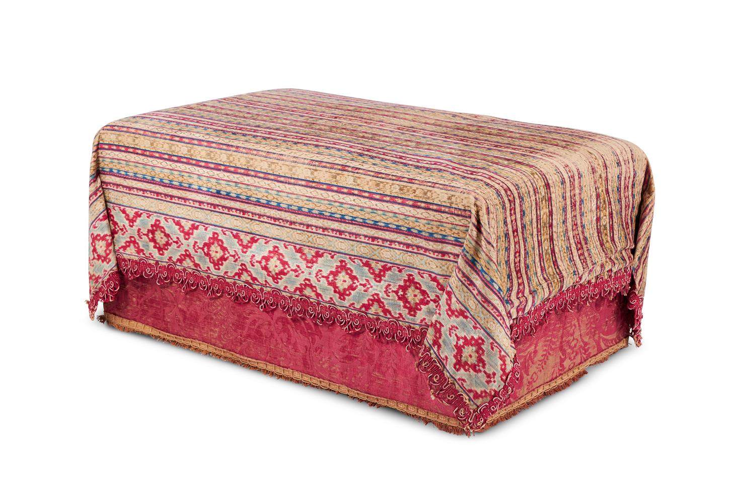 A TEXTILE COVERED OTTOMAN BY ROBERT KIME