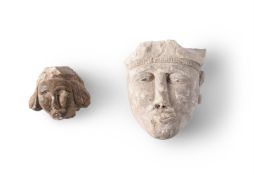 TWO FRAGMENTARY CARVED STONE HEADS, PROBABLY 11TH-13TH CENTURIES