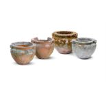FOUR WEATHERED SCROLL PATTERN GARDEN URNS, LATE 19TH/EARLY 20TH CENTURY