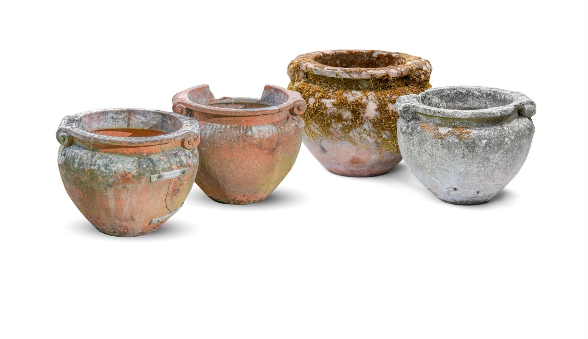 FOUR WEATHERED SCROLL PATTERN GARDEN URNS, LATE 19TH/EARLY 20TH CENTURY