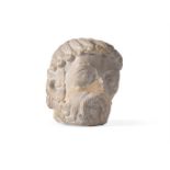 A ROMANESQUE LIMESTONE HEAD OF A BEARDED SAINT, FRENCH, 12TH CENTURY