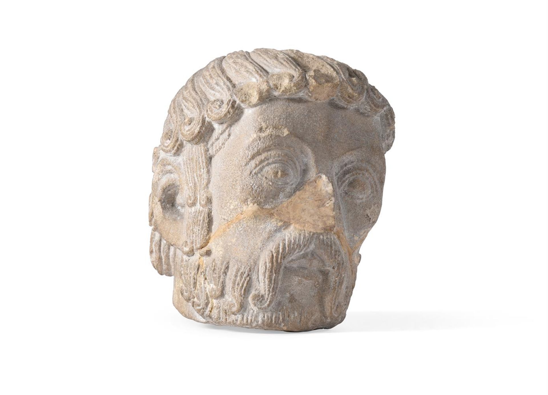 A ROMANESQUE LIMESTONE HEAD OF A BEARDED SAINT, FRENCH, 12TH CENTURY